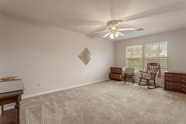 13303 E 95th Pl N, Owasso, OK 74055 - sitting room with carpet flooring, a ceiling fan, baseboards, and visible vents