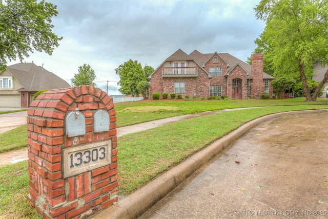 13303 E 95th Pl N, Owasso, OK 74055 - tudor home with brick siding and a front lawn