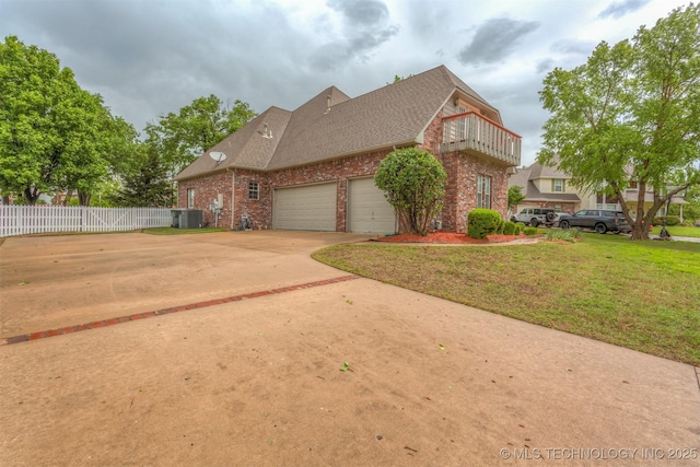13303 E 95th Pl N, Owasso, OK 74055 - view of side of property with central air condition unit, brick siding, fence, a balcony, and a yard