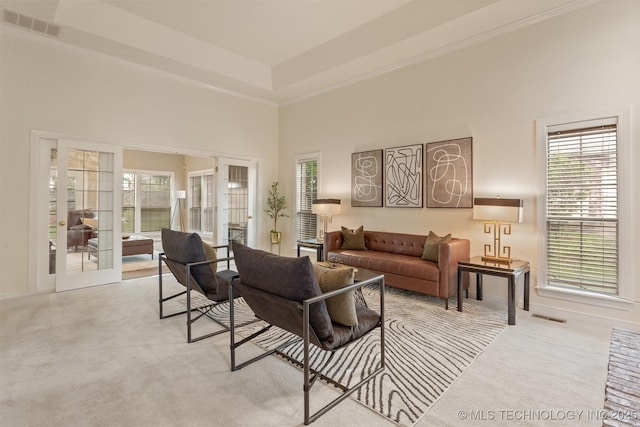 13303 E 95th Pl N, Owasso, OK 74055 - living area with light colored carpet, a towering ceiling, and visible vents