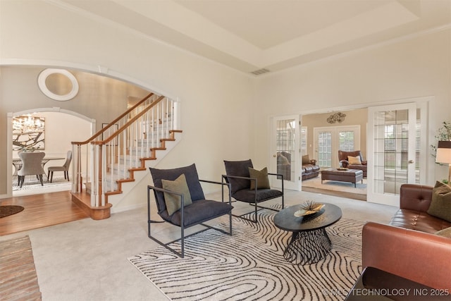 13303 E 95th Pl N, Owasso, OK 74055 - living room featuring carpet flooring, arched walkways, french doors, baseboards, and stairway