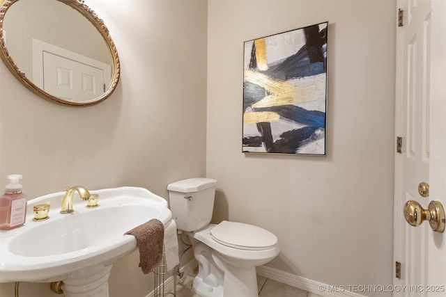 13303 E 95th Pl N, Owasso, OK 74055 - half bath with baseboards, a sink, tile patterned floors, and toilet