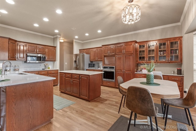 13303 E 95th Pl N, Owasso, OK 74055 - kitchen featuring appliances with stainless steel finishes, a sink, light countertops, light wood finished floors, and recessed lighting