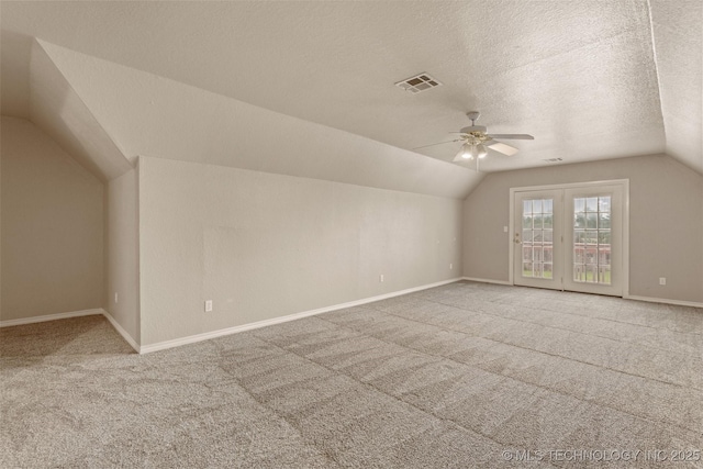 13303 E 95th Pl N, Owasso, OK 74055 - additional living space with visible vents, carpet floors, lofted ceiling, ceiling fan, and a textured ceiling