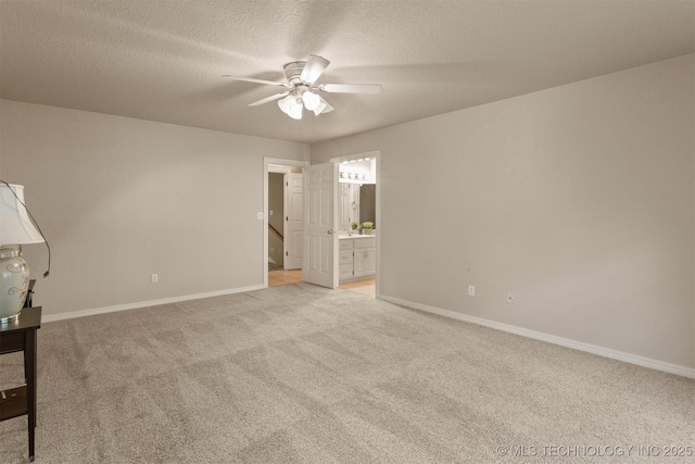 13303 E 95th Pl N, Owasso, OK 74055 - unfurnished bedroom featuring light colored carpet, connected bathroom, baseboards, and a textured ceiling