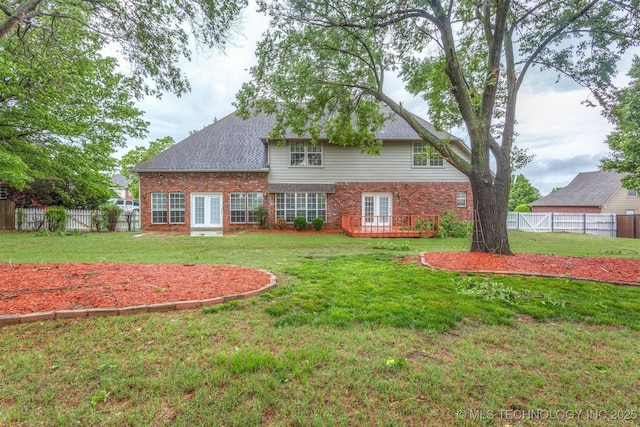13303 E 95th Pl N, Owasso, OK 74055 - rear view of property featuring a deck, a fenced backyard, french doors, brick siding, and a lawn