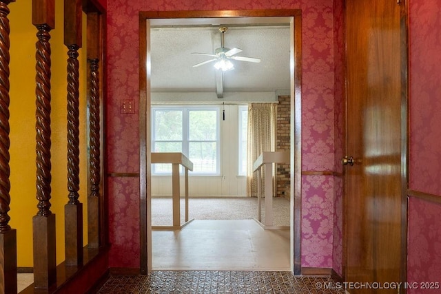 corridor with baseboards and wallpapered walls