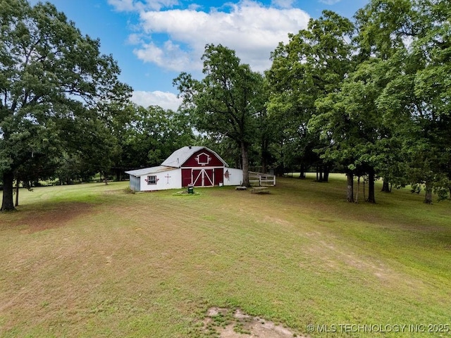 view of yard with a barn, an outbuilding, and a garage