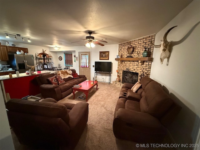 living room featuring a brick fireplace, a ceiling fan, and light carpet