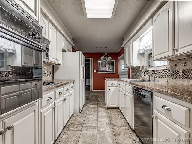 kitchen featuring decorative backsplash, white cabinetry, a textured ceiling, and black appliances