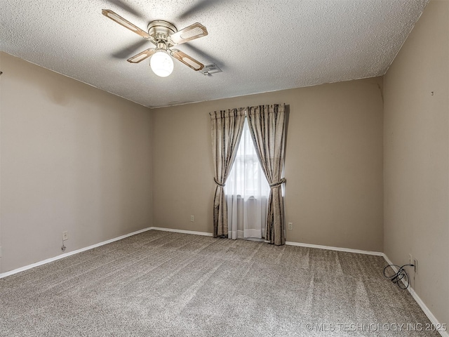 carpeted spare room with baseboards, ceiling fan, a textured ceiling, and visible vents