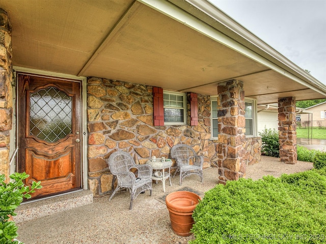 property entrance featuring stone siding
