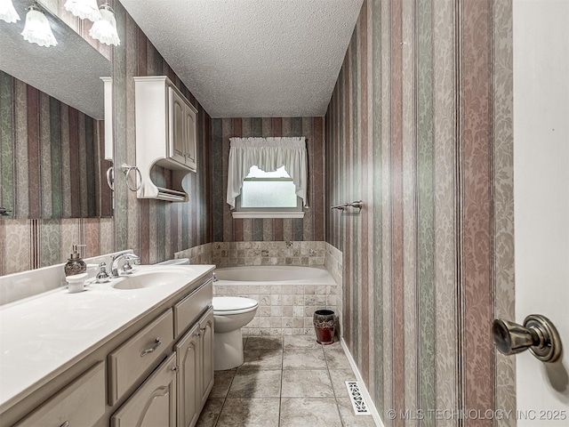 full bathroom with a textured ceiling, wallpapered walls, and a bath
