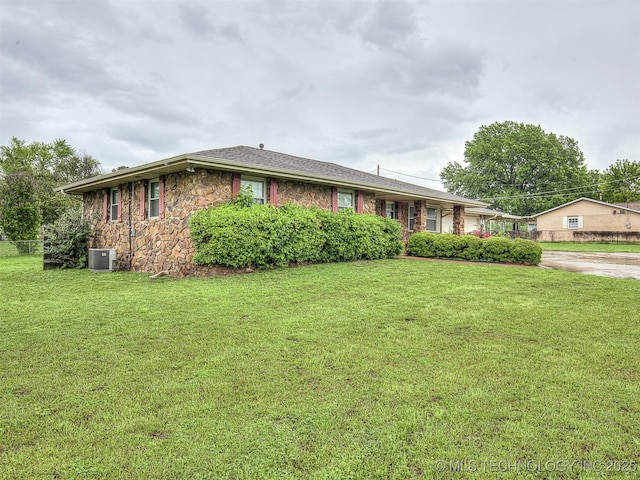 single story home featuring a front lawn, central air condition unit, and stone siding