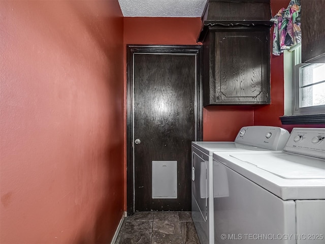 washroom with cabinet space, separate washer and dryer, and baseboards