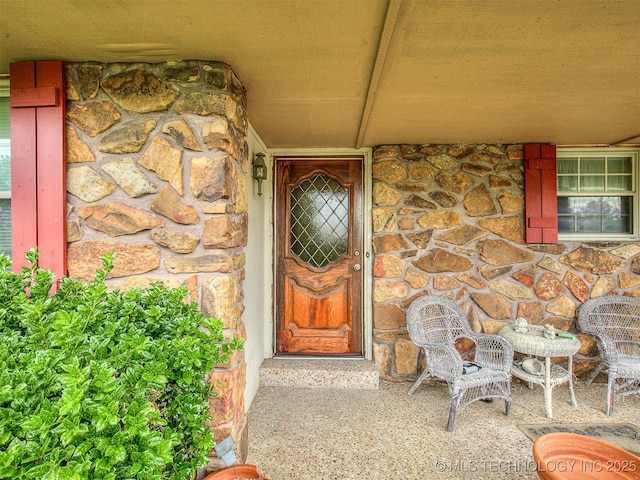 entrance to property featuring stone siding