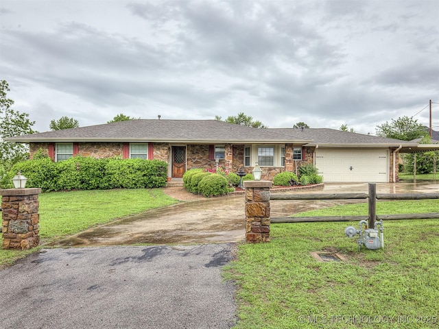 single story home with fence, an attached garage, a front lawn, and aphalt driveway