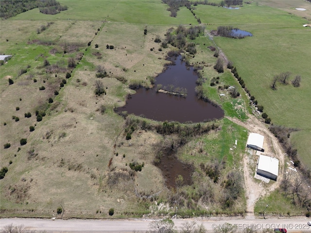 birds eye view of property with a water view and a rural view