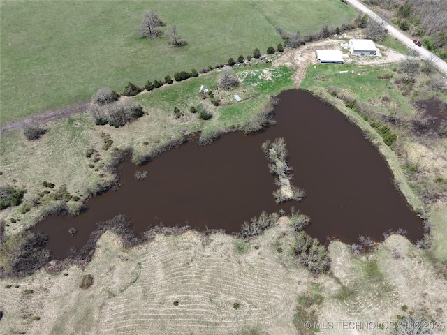 birds eye view of property with a water view and a rural view
