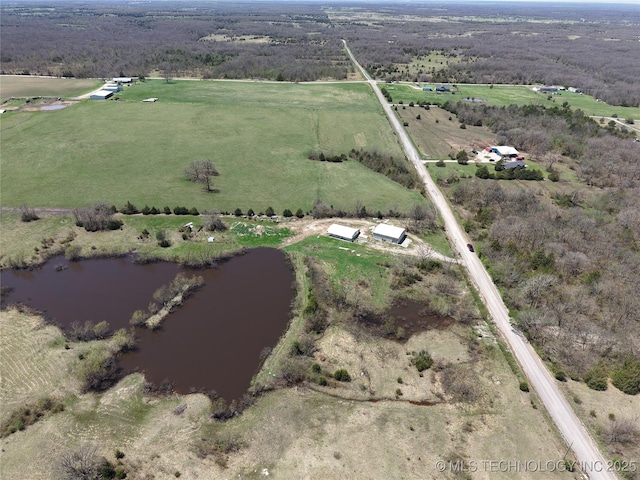 birds eye view of property featuring a water view and a rural view