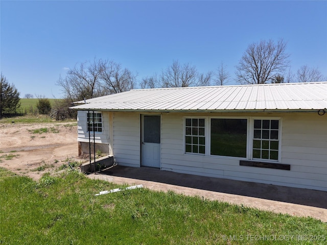 rear view of property with metal roof