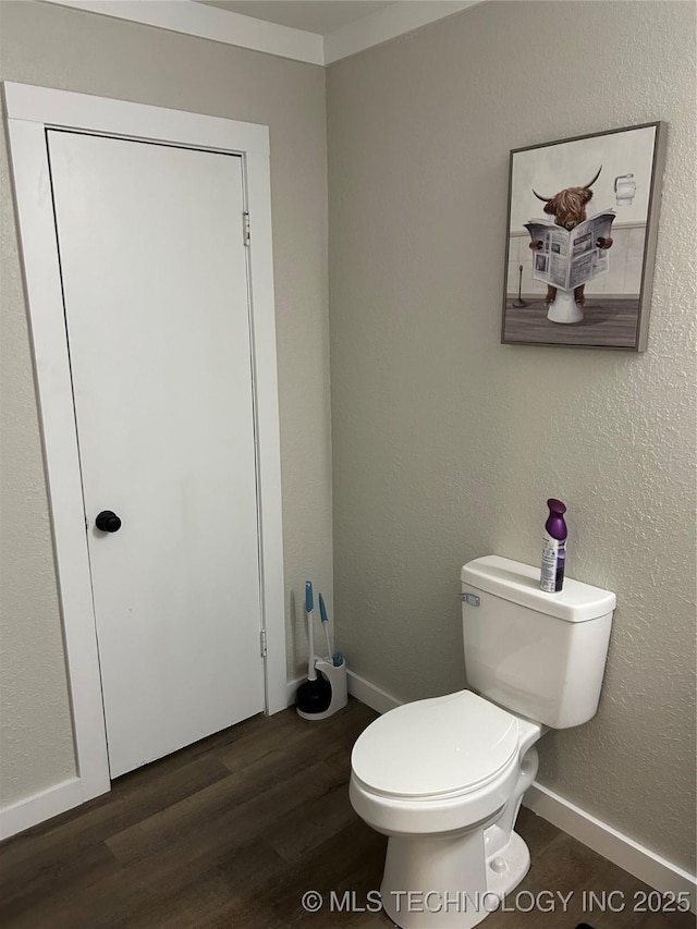 1705 Tower Dr, Ardmore, OK 73401 - bathroom with wood finished floors, toilet, and baseboards