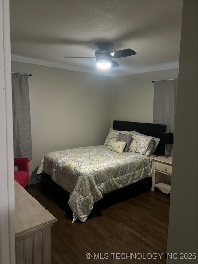 1705 Tower Dr, Ardmore, OK 73401 - bedroom with dark wood-type flooring, crown molding, and ceiling fan