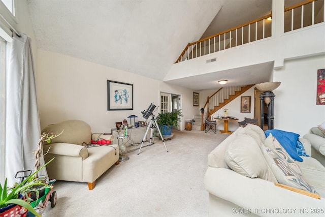 25805 S Clayton Ave, Claremore, OK 74019 - carpeted living area featuring stairway, high vaulted ceiling, and visible vents