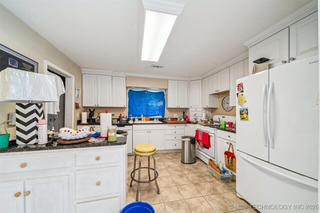 25805 S Clayton Ave, Claremore, OK 74019 - kitchen with white appliances, white cabinetry, dark countertops, and a sink