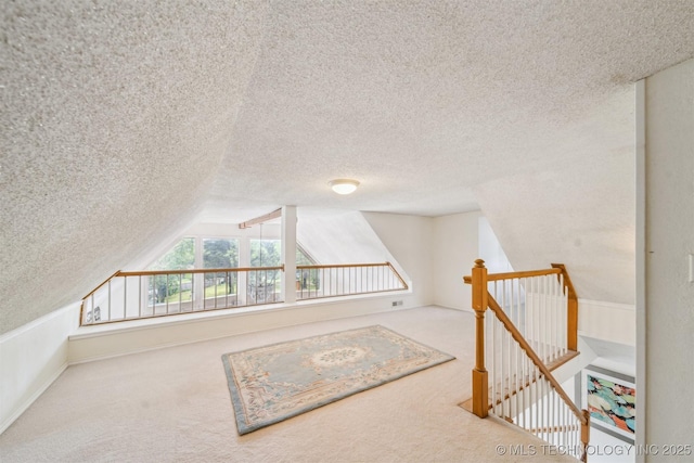 25805 S Clayton Ave, Claremore, OK 74019 - additional living space featuring carpet floors, a textured ceiling, and lofted ceiling