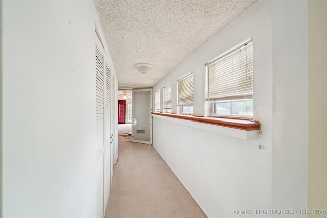 25805 S Clayton Ave, Claremore, OK 74019 - hallway with a textured ceiling, visible vents, and light carpet