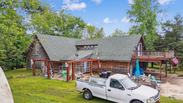 25805 S Clayton Ave, Claremore, OK 74019 - view of front facade with a patio, a deck, a shingled roof, and a front lawn