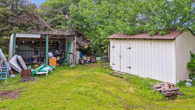 25805 S Clayton Ave, Claremore, OK 74019 - view of pole building featuring a lawn and a storage shed