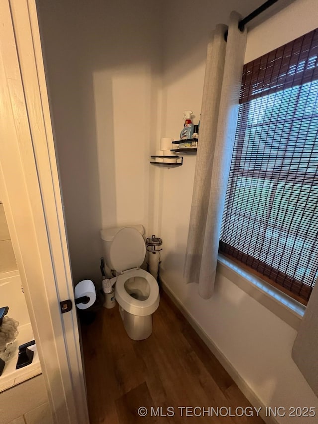 bathroom featuring toilet and wood finished floors