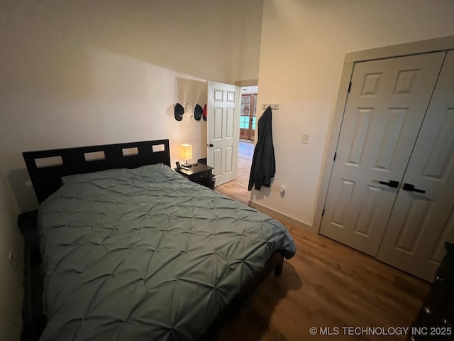 bedroom featuring baseboards and wood finished floors