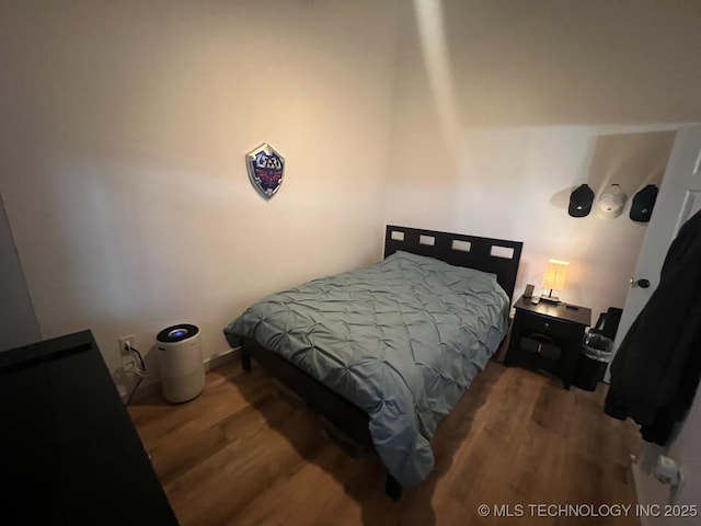 bedroom featuring wood finished floors