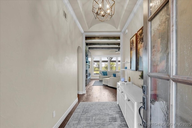 hall with arched walkways, baseboards, dark wood-style floors, an inviting chandelier, and ornamental molding