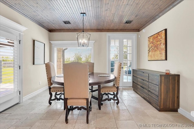 dining area with baseboards, ornamental molding, a wealth of natural light, and an inviting chandelier