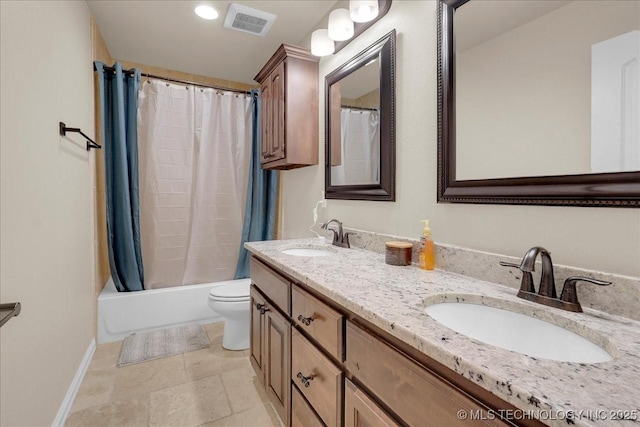 full bathroom with double vanity, toilet, visible vents, and a sink