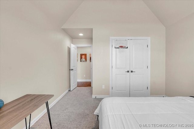 carpeted bedroom with recessed lighting, baseboards, lofted ceiling, and a closet