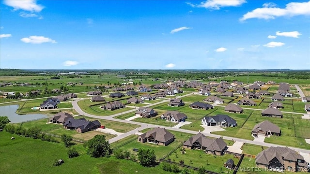 drone / aerial view with a residential view and a water view