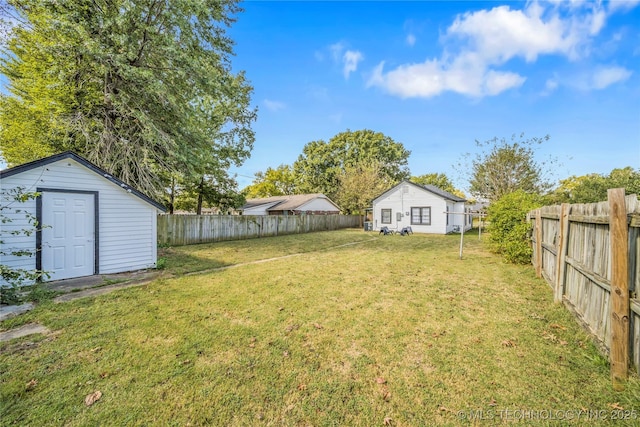 view of yard featuring an outdoor structure and a fenced backyard