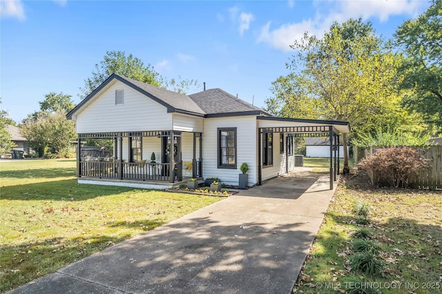 exterior space featuring fence, an attached carport, a porch, a front yard, and driveway