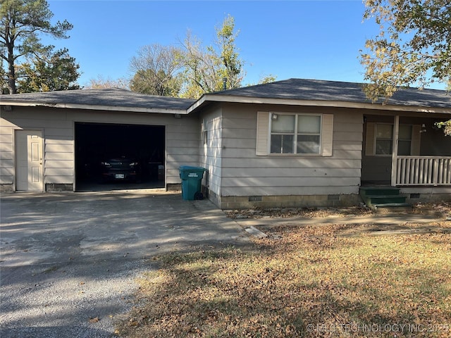 16 B St NW, Inola, OK 74036 - view of side of property featuring a garage, covered porch, a shingled roof, crawl space, and driveway