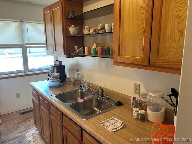 16 B St NW, Inola, OK 74036 - kitchen with brown cabinetry, a sink, visible vents, and light countertops