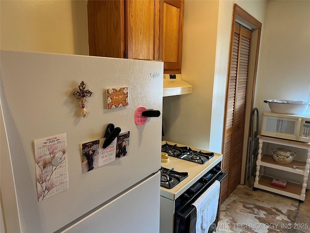 16 B St NW, Inola, OK 74036 - kitchen with light countertops, brown cabinets, exhaust hood, and white appliances