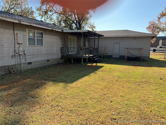 16 B St NW, Inola, OK 74036 - rear view of house featuring a wooden deck, fence, a shingled roof, crawl space, and a lawn