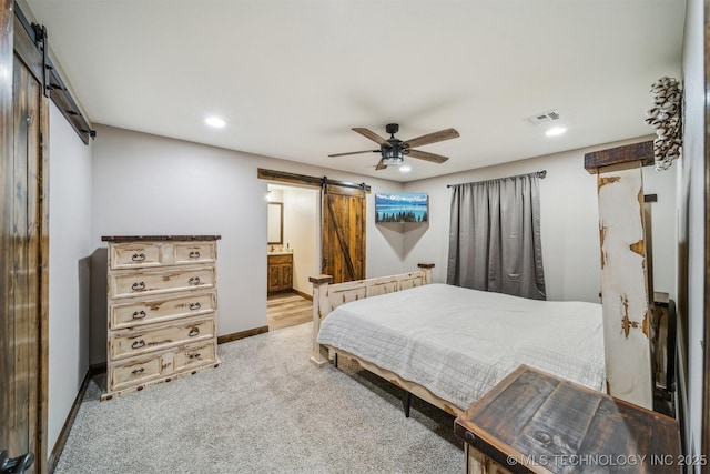 bedroom featuring visible vents, light carpet, baseboards, recessed lighting, and a barn door