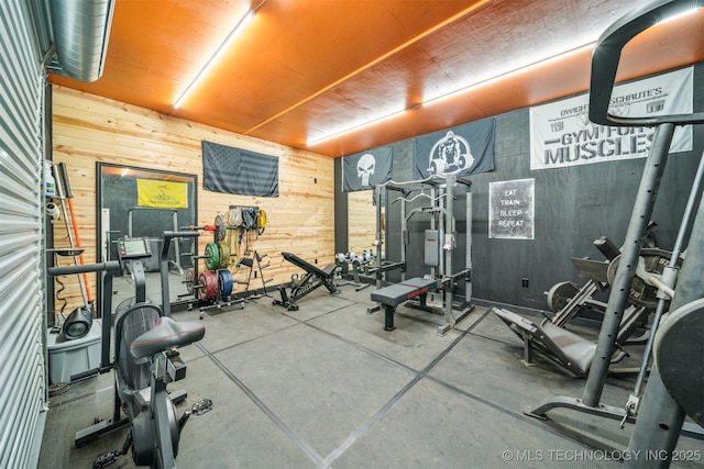 workout area featuring wooden walls