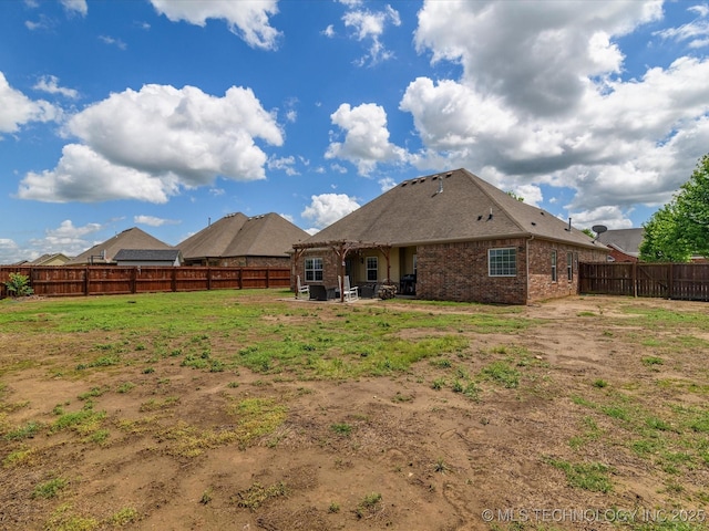 5406 Ashbrook Dr, Bartlesville, OK 74006 - back of property with brick siding, a patio, a yard, and a fenced backyard